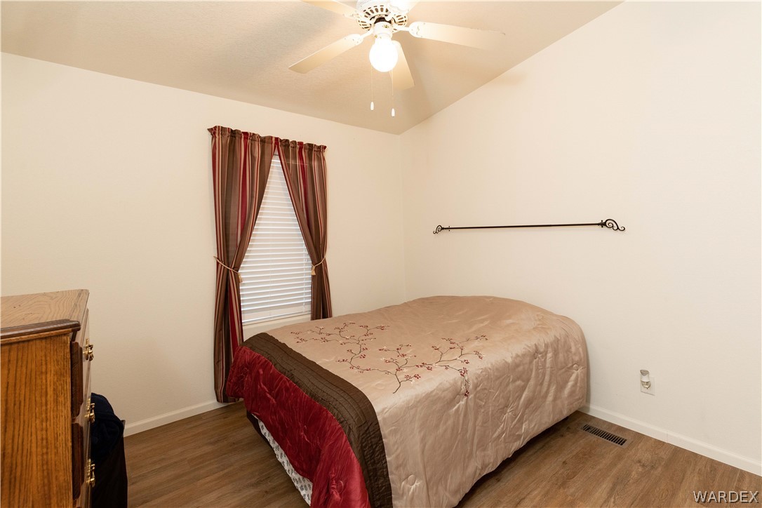 4102 Cibola Road Golden Valley, AZ 86413 - Photo 26 of 71 a bedroom with a bed and a chandelier