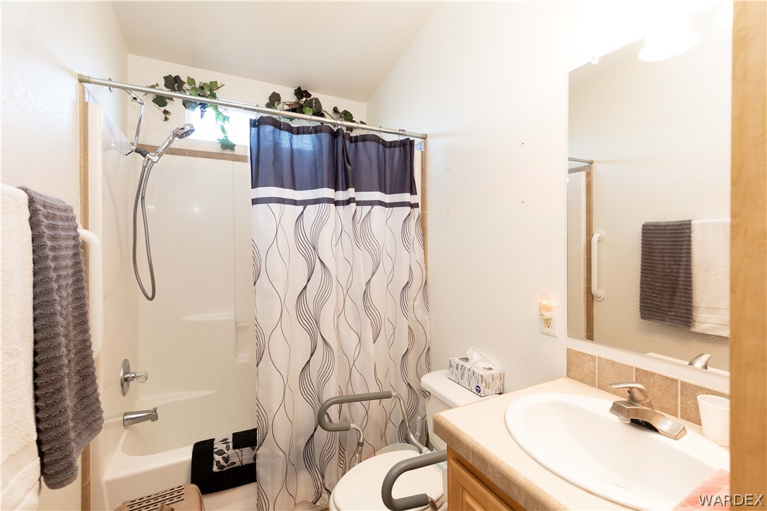 4102 Cibola Road Golden Valley, AZ 86413 - Photo 28 of 71 a bathroom with a sink vanity mirror and shower