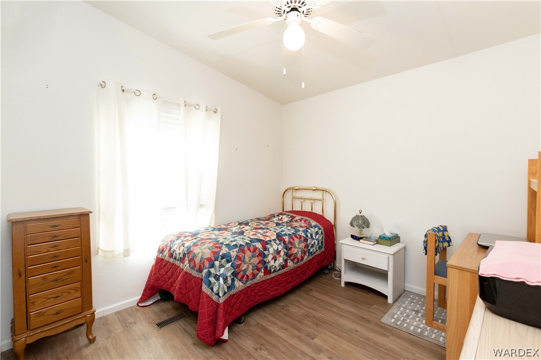 4102 Cibola Road Golden Valley, AZ 86413 - Photo 29 of 71 a bedroom with a bed and a chandelier