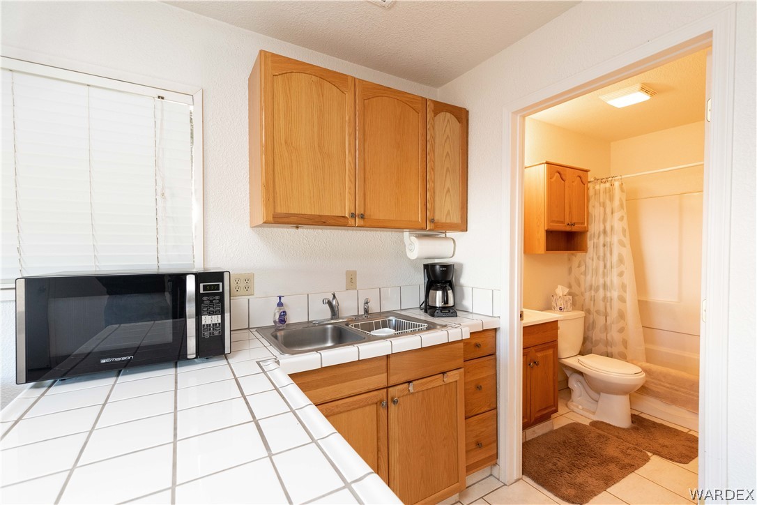 4102 Cibola Road Golden Valley, AZ 86413 - Photo 43 of 71 a kitchen with a sink cabinets and appliances