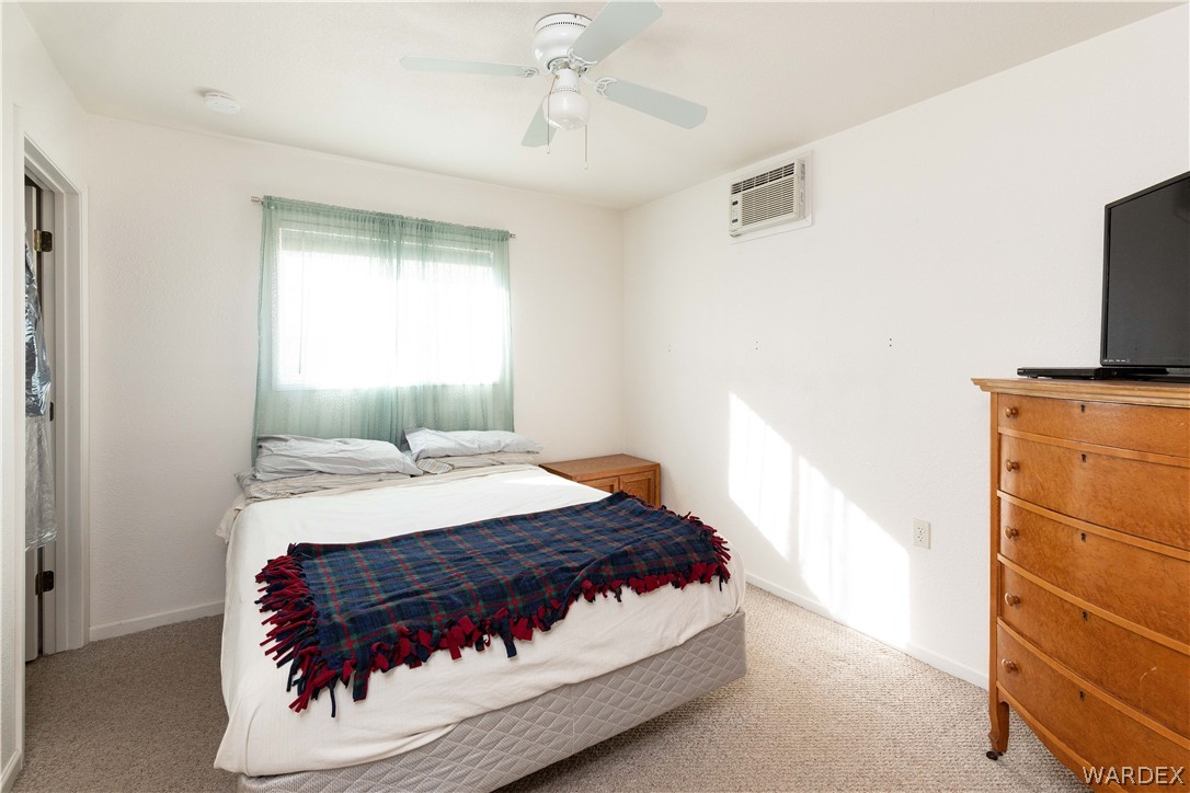 4102 Cibola Road Golden Valley, AZ 86413 - Photo 45 of 71 a bedroom with a bed and a flat tv screen on dresser