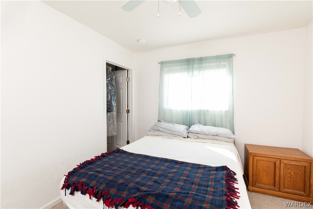 4102 Cibola Road Golden Valley, AZ 86413 - Photo 46 of 71 a bedroom with a bed and wooden floor
