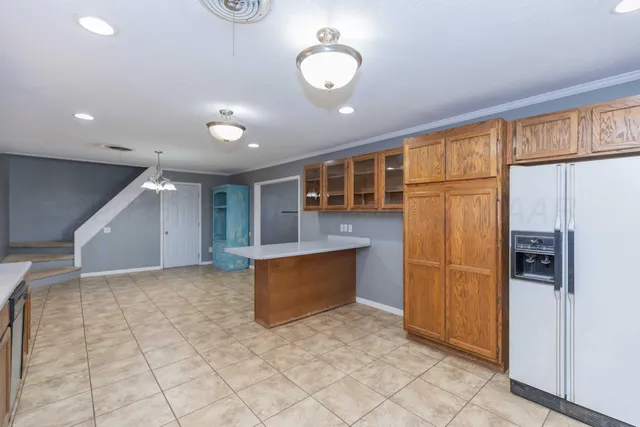 a view of kitchen with refrigerator cabinets and outdoor view