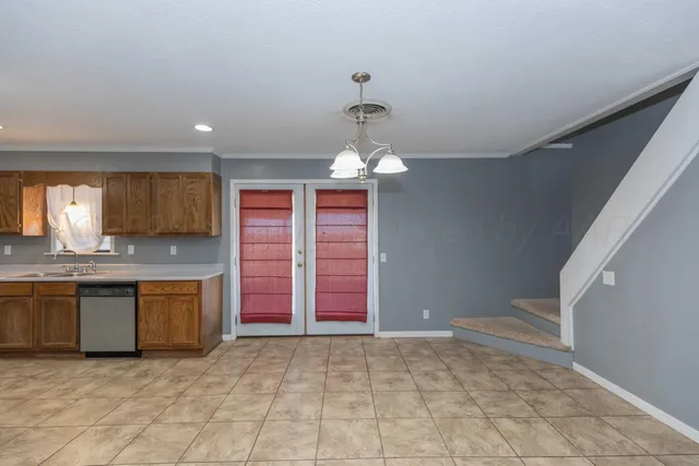 a view of a kitchen with a sink and dishwasher cabinets