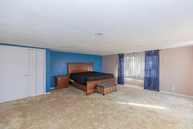 a bedroom with a bed and a table in it