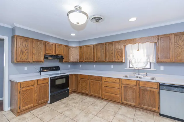 a kitchen with a sink cabinets and window