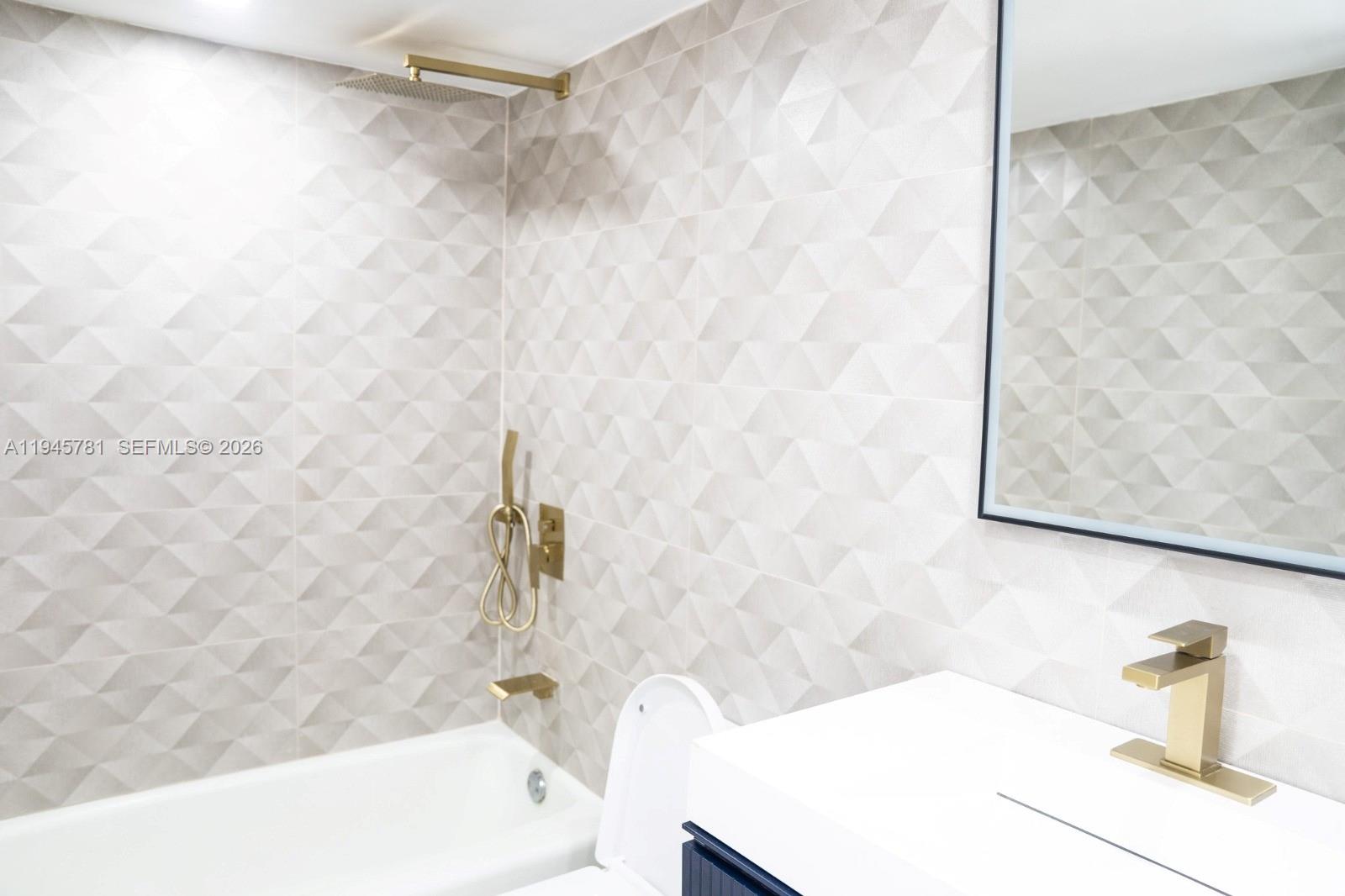 220 Southwest 9th Avenue, Unit 306 Hallandale Beach, FL 33009 - Photo 13 of 30 a bathroom with a bathtub and shower