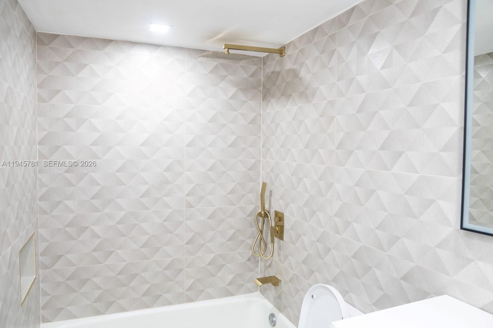 220 Southwest 9th Avenue, Unit 306 Hallandale Beach, FL 33009 - Photo 14 of 30 a bath tub sitting in a bathroom