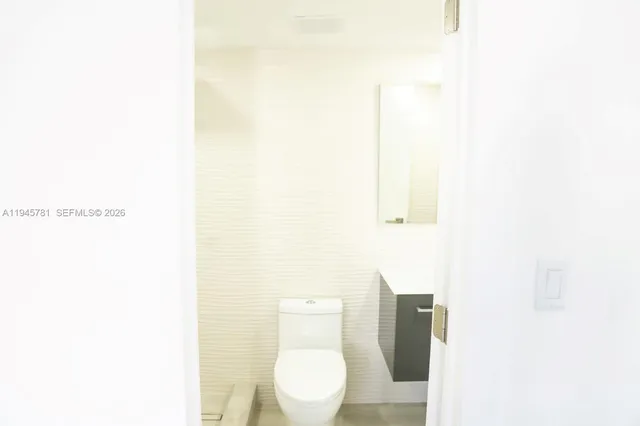 a bathroom with a toilet and a sink