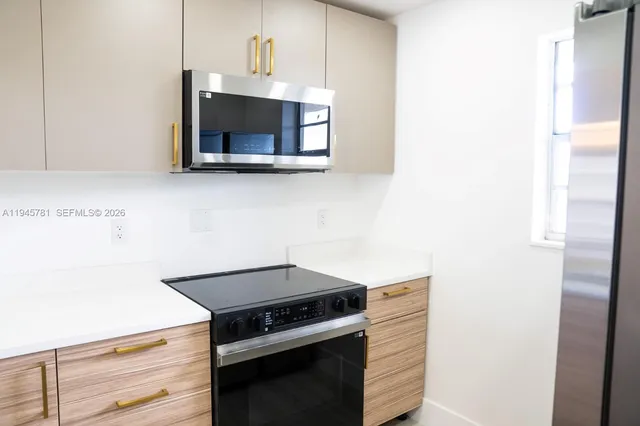 a kitchen with a stove and a microwave