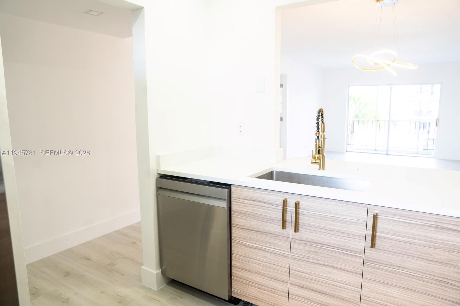 220 Southwest 9th Avenue, Unit 306 Hallandale Beach, FL 33009 - Photo 24 of 30 a kitchen with a sink and a window