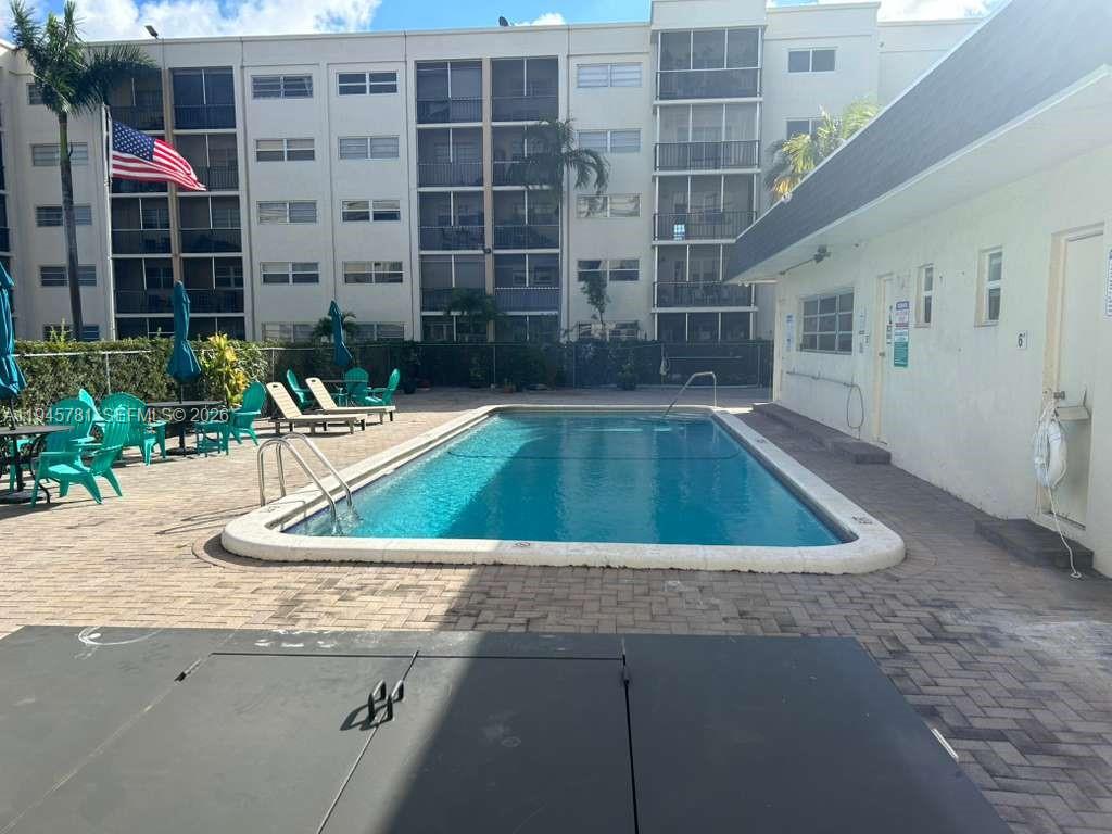 220 Southwest 9th Avenue, Unit 306 Hallandale Beach, FL 33009 - Photo 28 of 30 a view of swimming pool with outdoor seating
