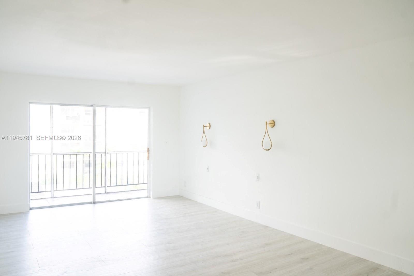 220 Southwest 9th Avenue, Unit 306 Hallandale Beach, FL 33009 - Photo 3 of 30 a view of an empty room with a window