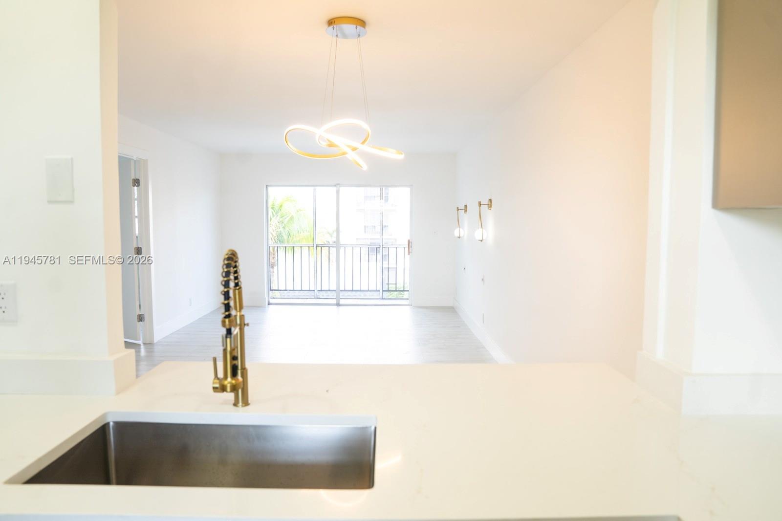 220 Southwest 9th Avenue, Unit 306 Hallandale Beach, FL 33009 - Photo 6 of 30 a view of a living room with a window