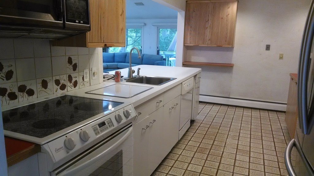 4 York Road Newton, MA 02468 - Photo 4 of 7 a kitchen with a sink stove and cabinets