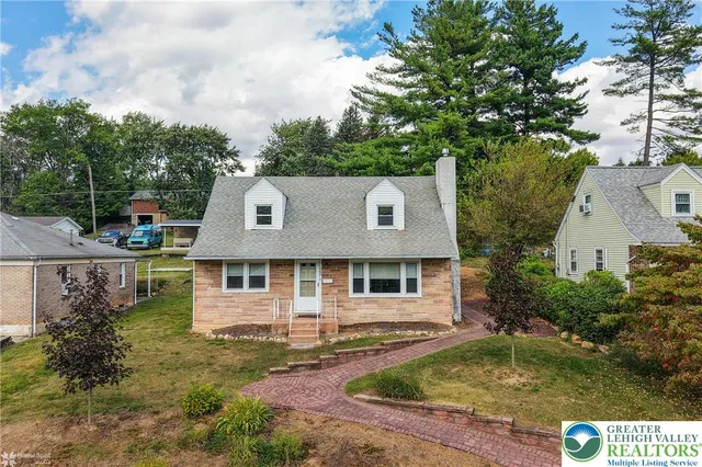 a view of a house with a yard balcony and tree s