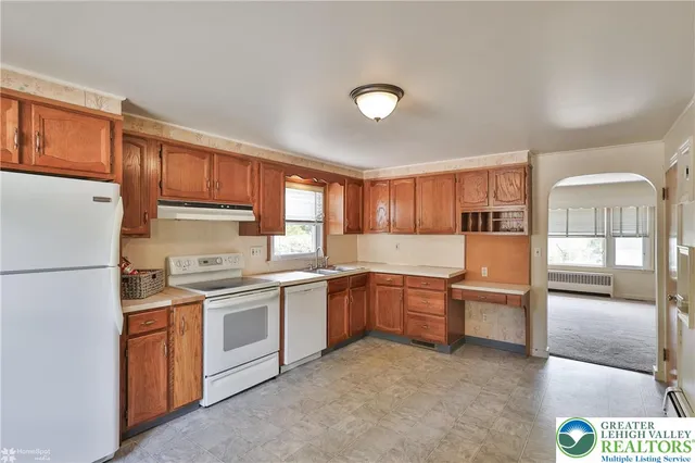 a kitchen with a sink stove and refrigerator