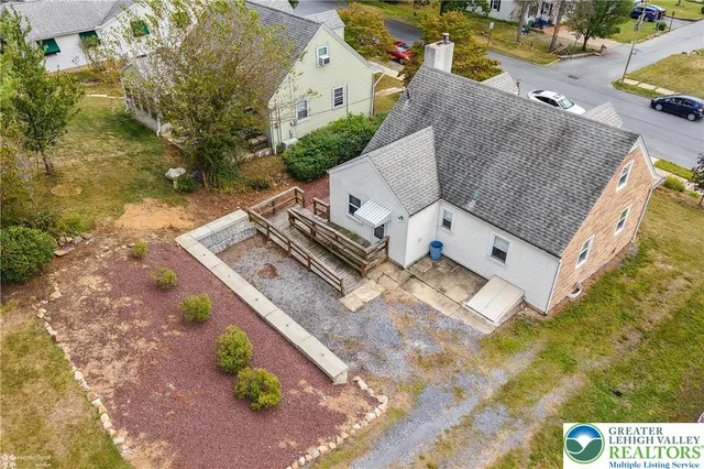 an aerial view of a house with a yard and trees