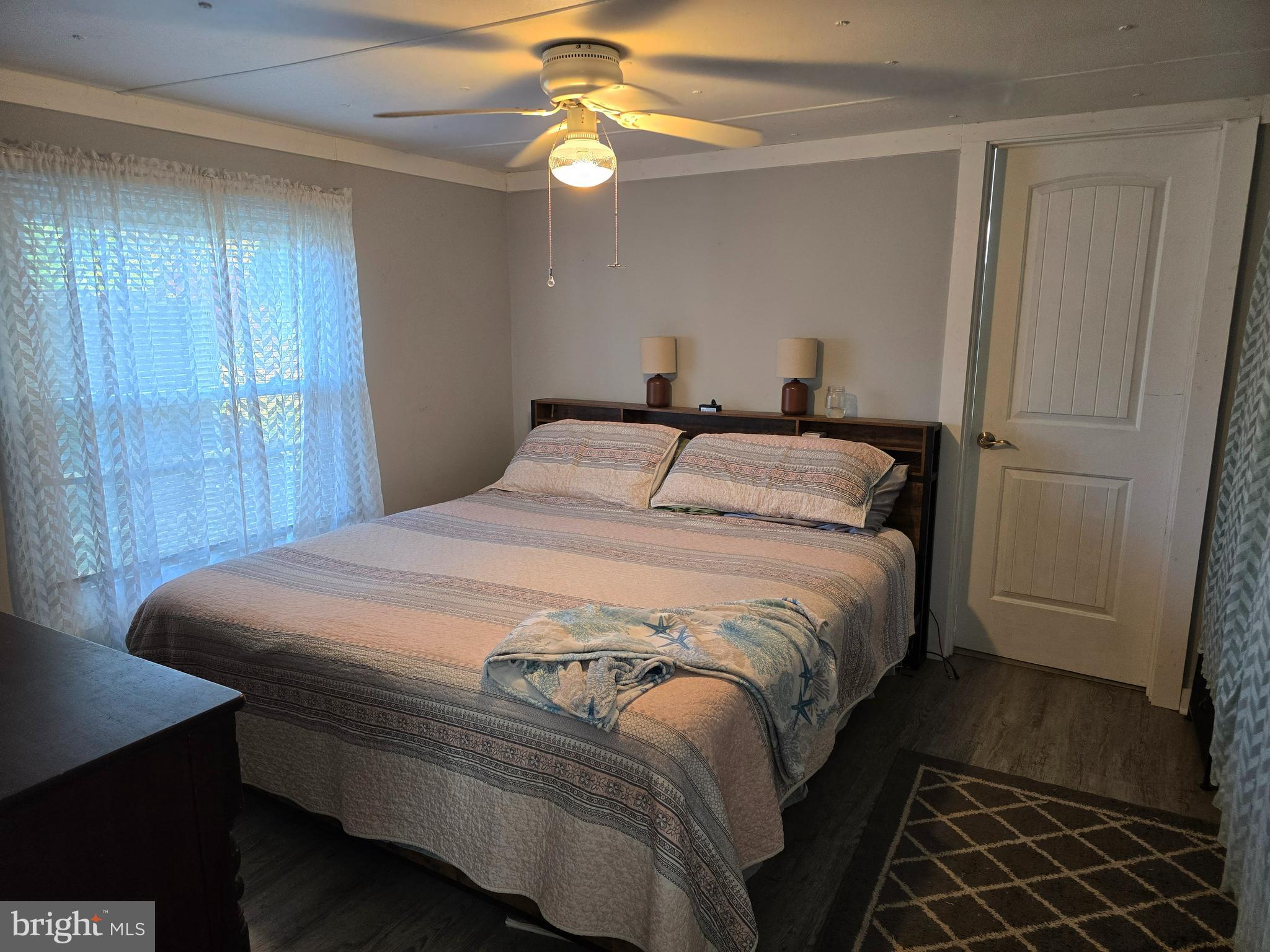 33500 Clover Street Lewes, DE 19958 - Photo 17 of 39 a bedroom with a bed and a chandelier