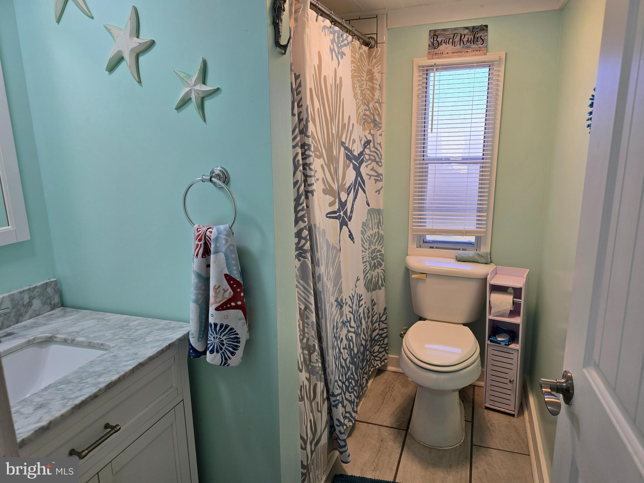 33500 Clover Street Lewes, DE 19958 - Photo 24 of 39 a bathroom with a granite countertop toilet and a sink