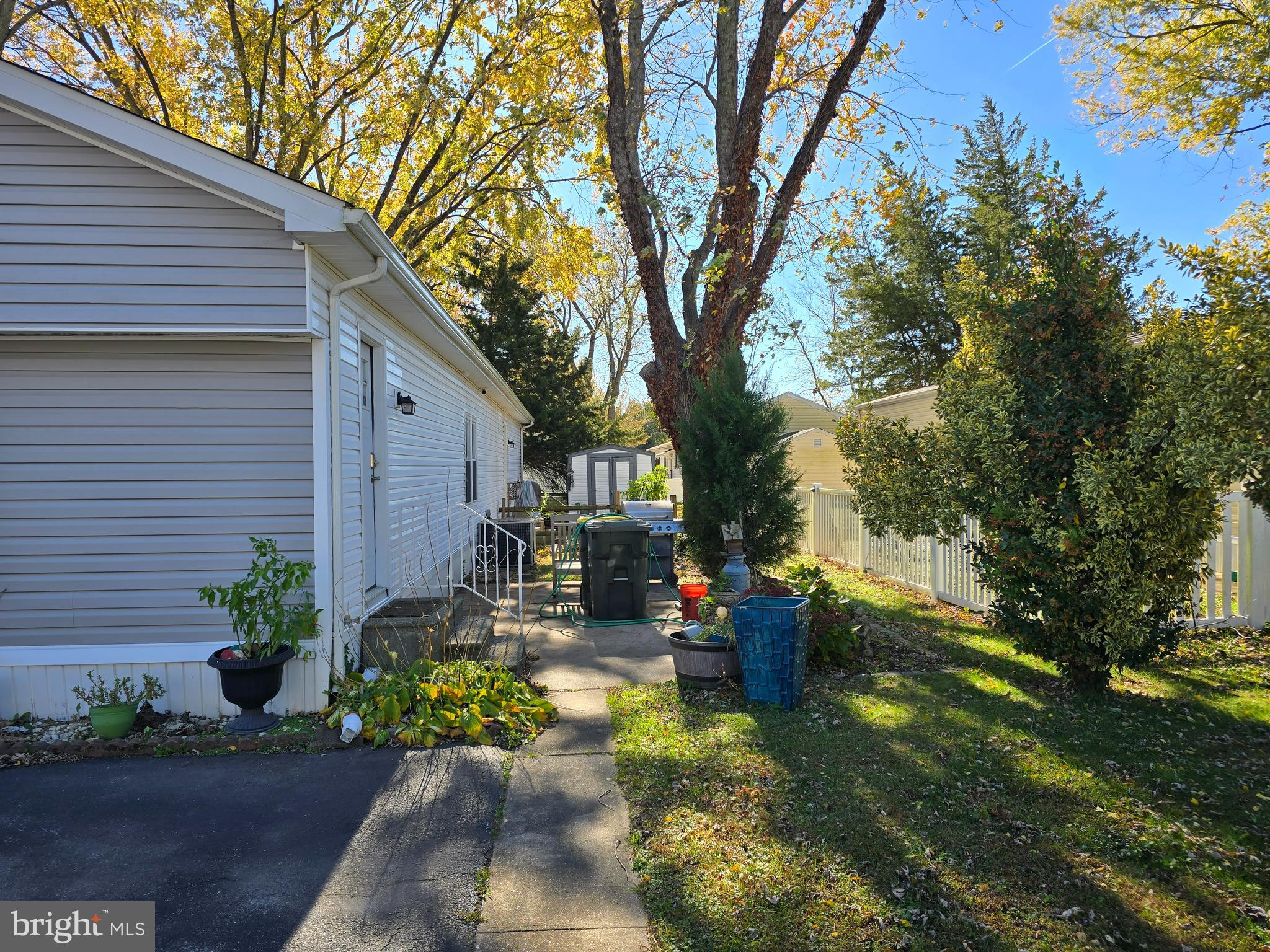 33500 Clover Street Lewes, DE 19958 - Photo 4 of 39 a view of a patio with table and chairs potted plants and large tree