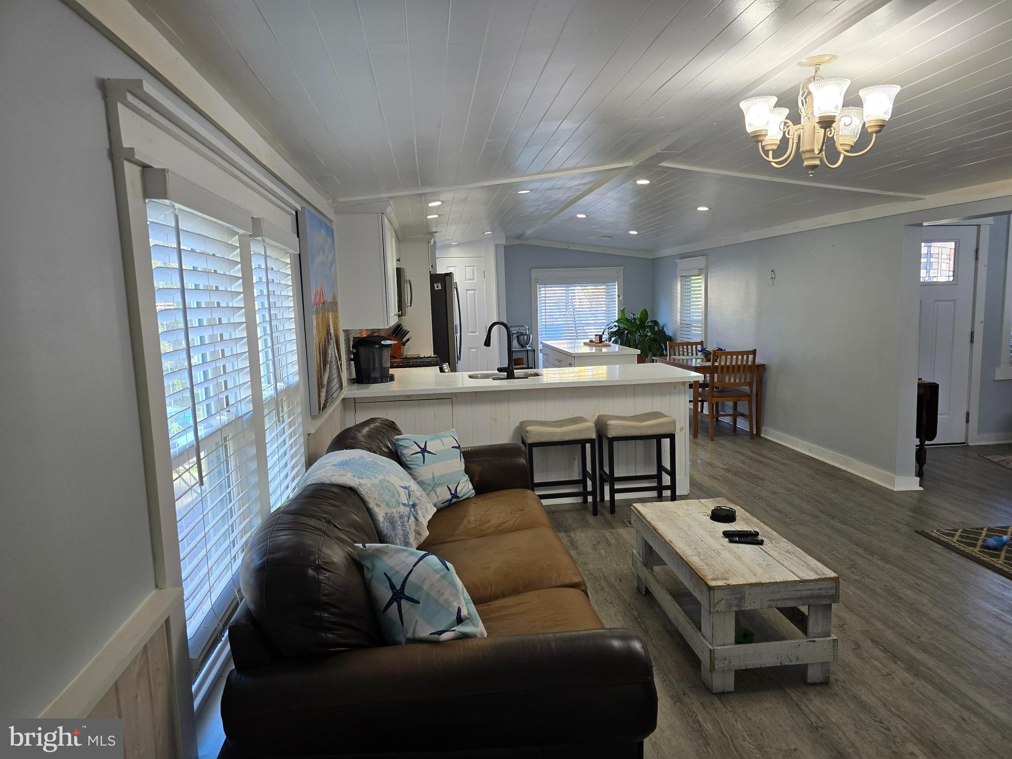 33500 Clover Street Lewes, DE 19958 - Photo 9 of 39 a living room with furniture and a chandelier