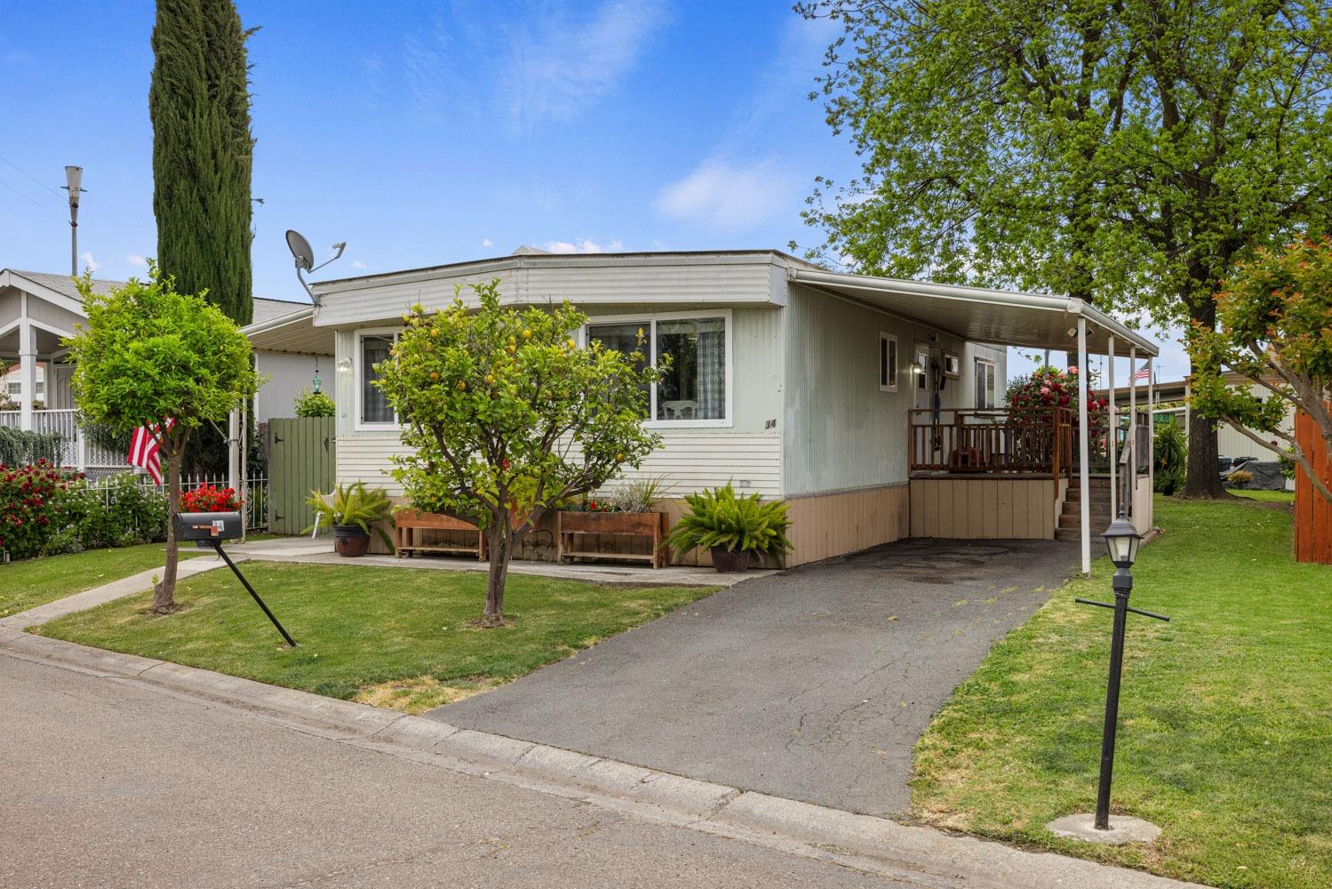 4350 Cherokee Road, Unit 34 Stockton, CA 95215 - Photo 1 of 1 a house view with a garden space