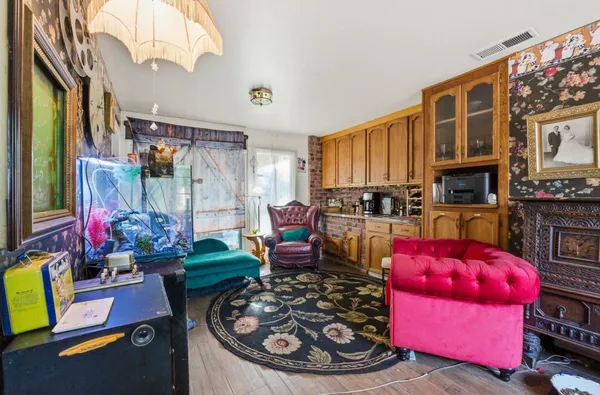 a living room with patio furniture and a chandelier