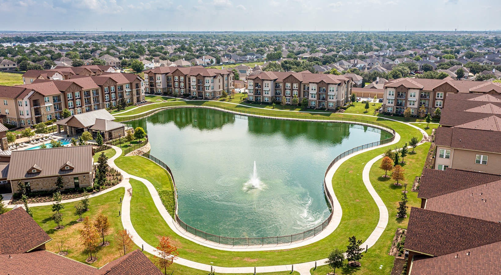 1700 Katy Fort Bend Road, Unit 7110 Katy, TX 77493 - Photo 25 of 30 an aerial view of a swimming pool with outdoor seating and city view