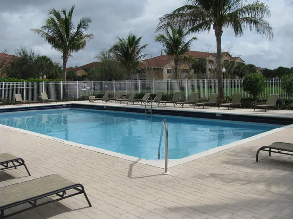 a view of a swimming pool with a table and chairs