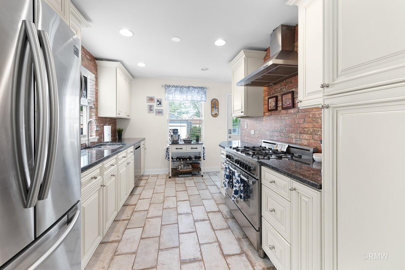 735 Spring Road Elmhurst, IL 60126 - Photo 19 of 34 a kitchen with stainless steel appliances granite countertop a stove a sink and a refrigerator