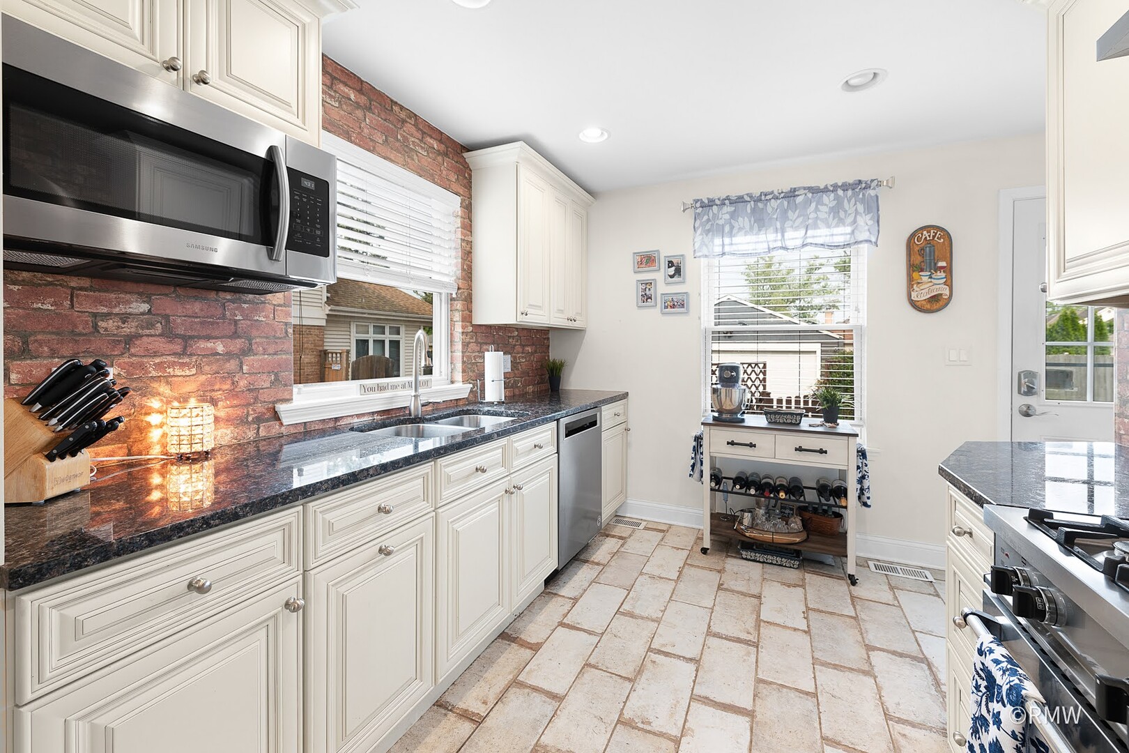 735 Spring Road Elmhurst, IL 60126 - Photo 20 of 34 a kitchen with stainless steel appliances a sink a stove a microwave and cabinets