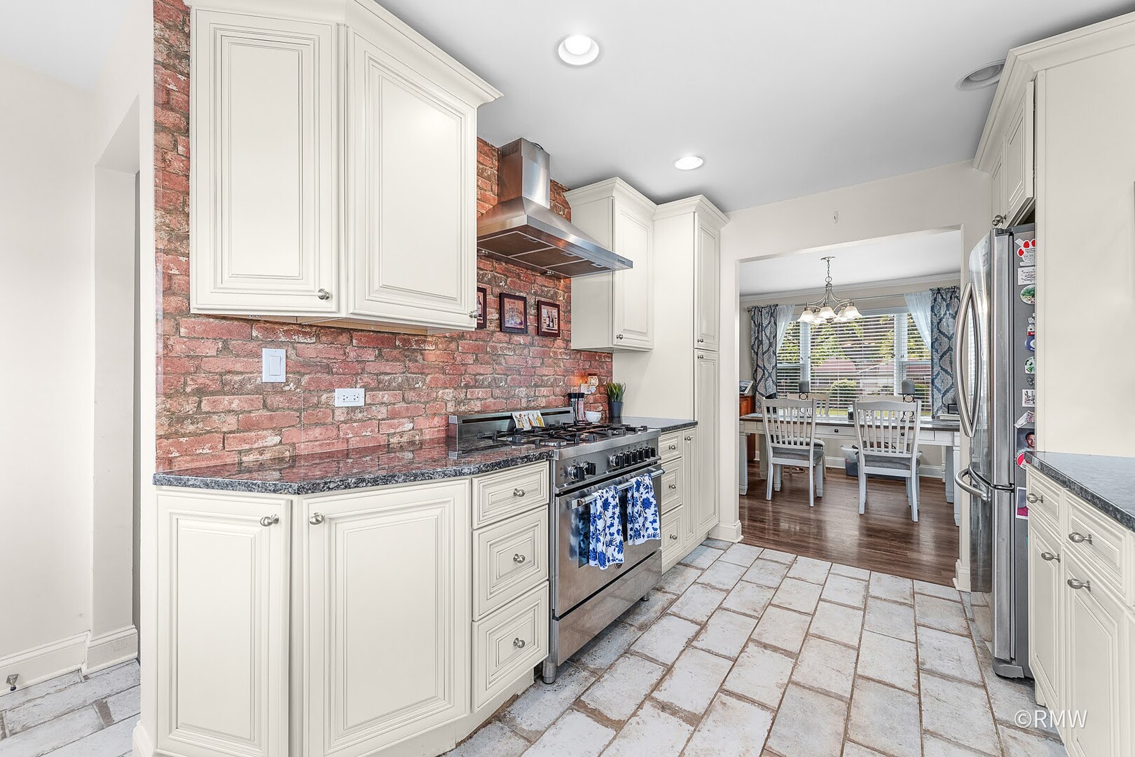 735 Spring Road Elmhurst, IL 60126 - Photo 23 of 34 a kitchen with stainless steel appliances granite countertop a stove a sink and a microwave