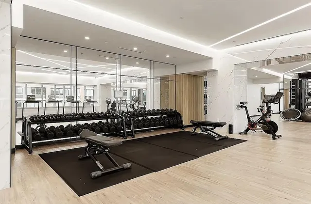a room with gym equipment and a large window