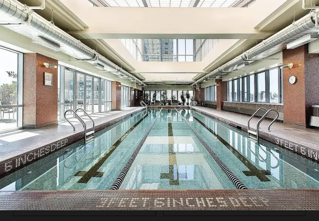 a bathroom with a sink vanity granite and shower
