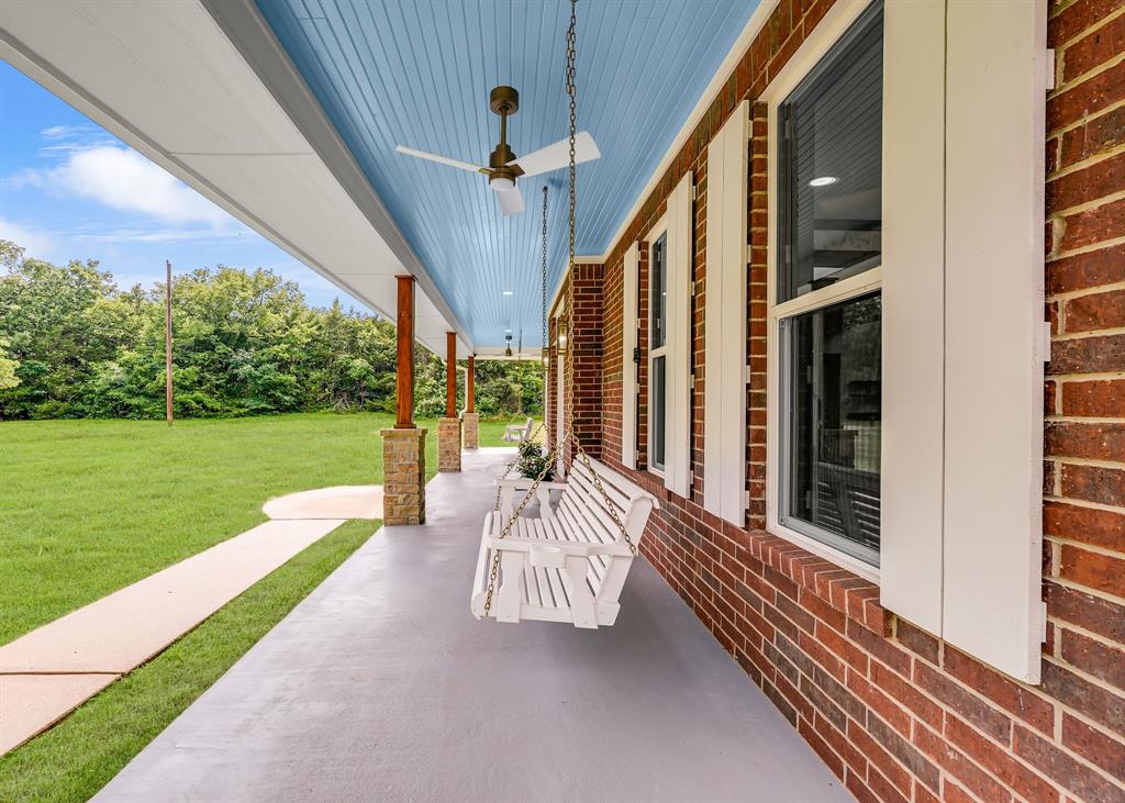 1037 Harrison Road Denison, TX 75021 - Photo 6 of 39 Expansive covered front porch featuring a light blue beadboard ceiling with recessed lighting and ceiling fans