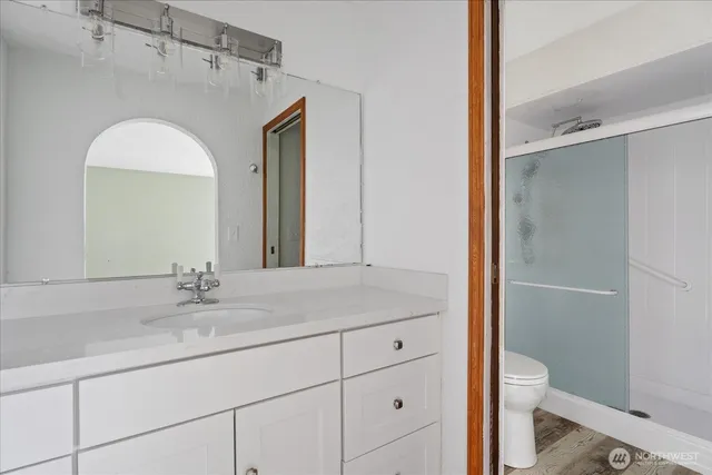 a white toilet next to a bathroom