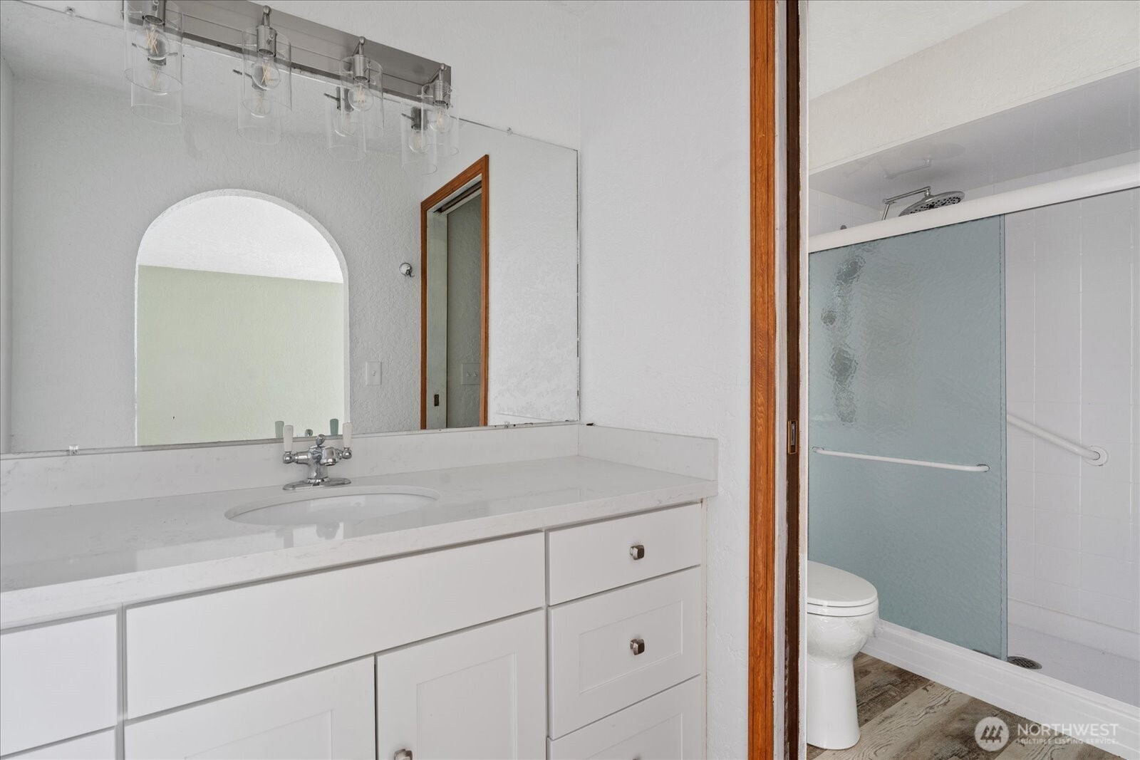 12600 4th Avenue West, Unit 7H Everett, WA 98204 - Photo 18 of 30 a bathroom with a granite countertop sink a toilet and a mirror