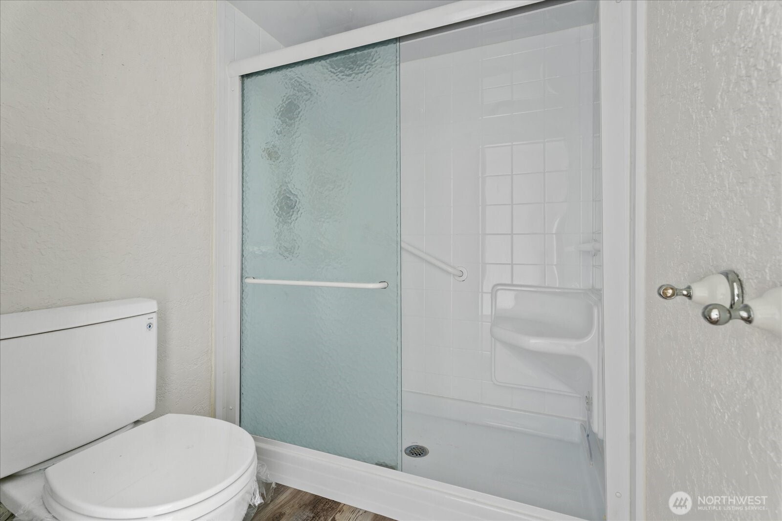 12600 4th Avenue West, Unit 7H Everett, WA 98204 - Photo 19 of 30 a white toilet next to a bathroom