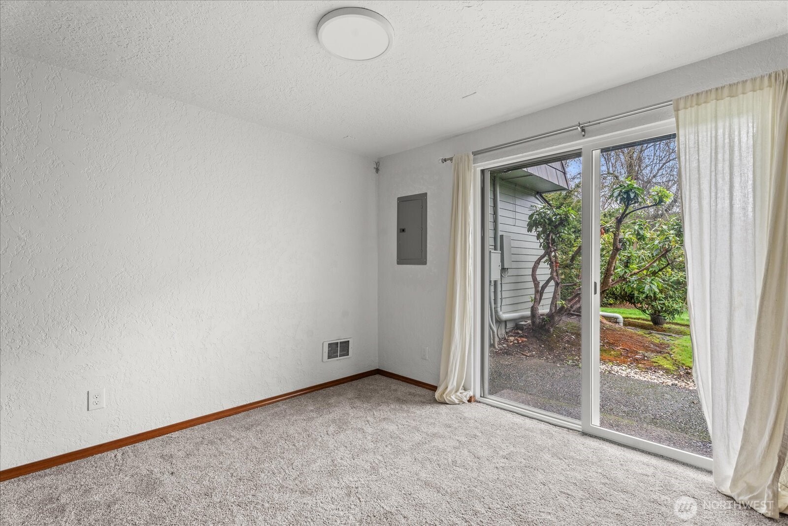 12600 4th Avenue West, Unit 7H Everett, WA 98204 - Photo 10 of 30 an empty room with wooden floor and windows