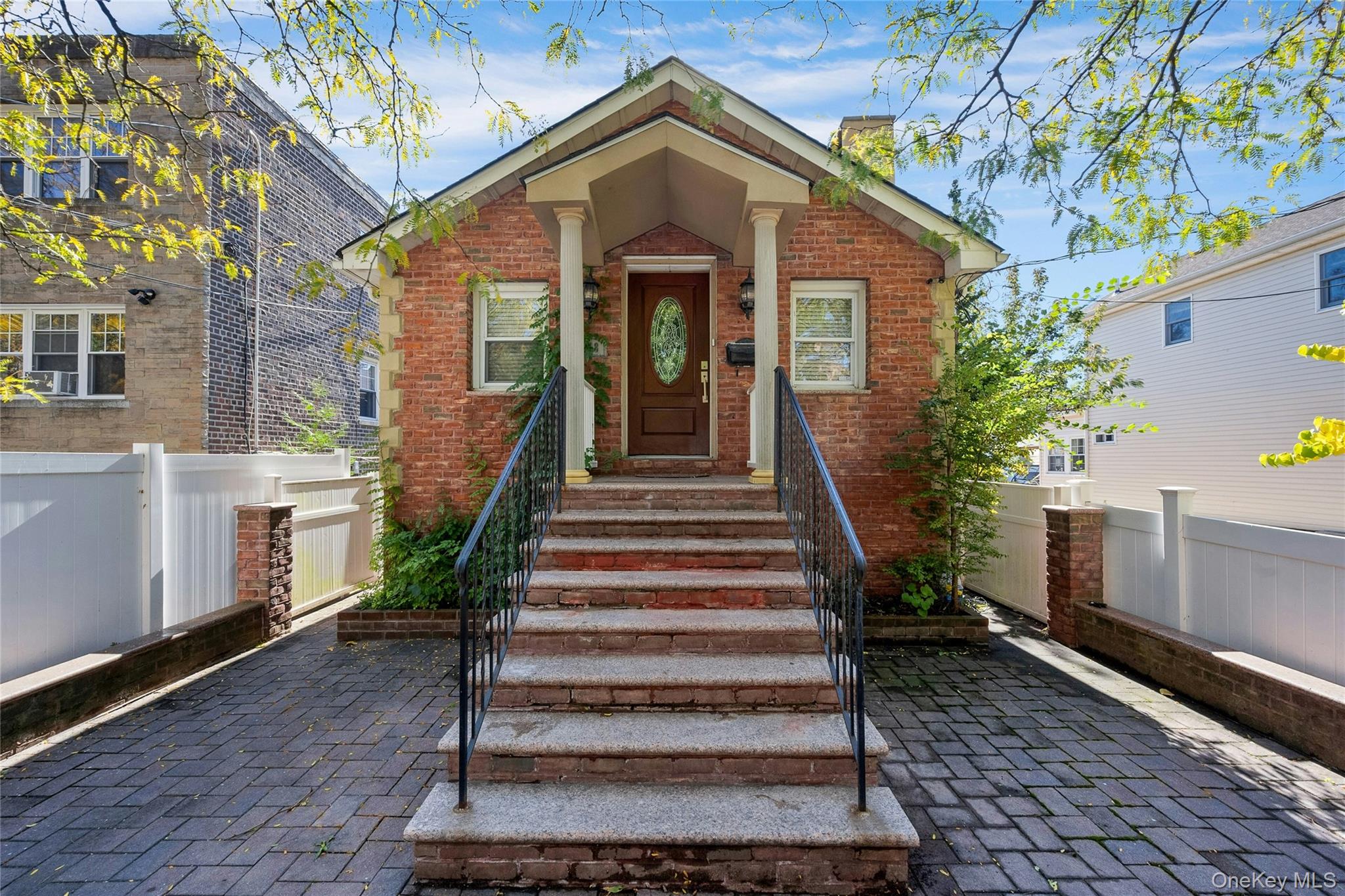 a view of a house with wooden fence and large windows