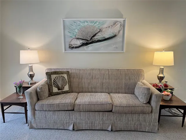 a living room with furniture a lamp and a lamp