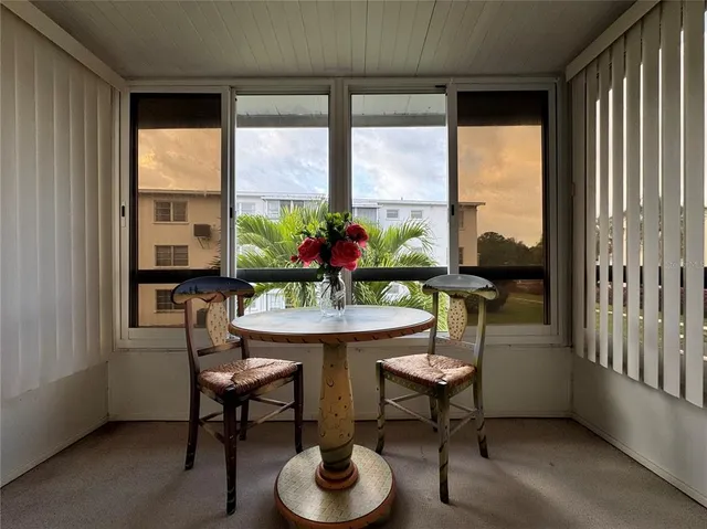 a dining room with furniture window and outside view