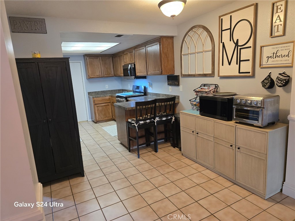 11504 Los Molinos Way Riverside, CA 92505 - Photo 12 of 40 a kitchen with stainless steel appliances granite countertop a refrigerator and a stove top oven