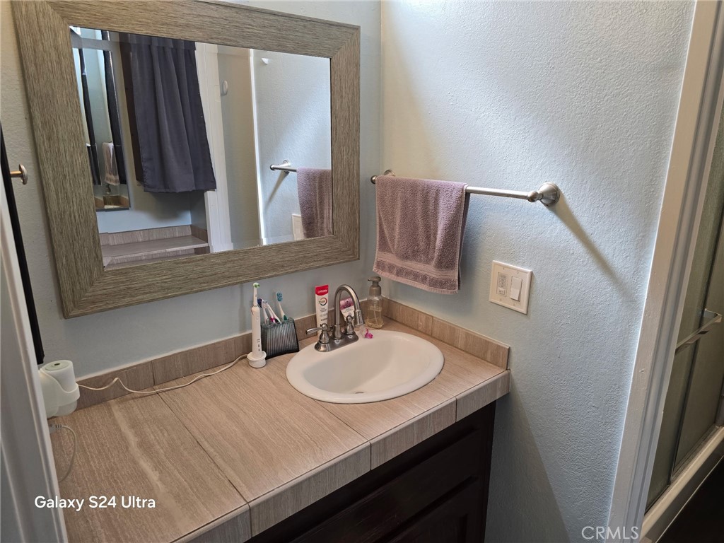 11504 Los Molinos Way Riverside, CA 92505 - Photo 27 of 40 a bathroom with a sink and a mirror