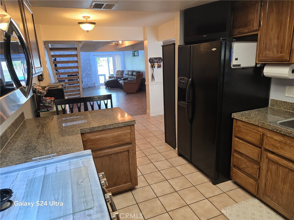 11504 Los Molinos Way Riverside, CA 92505 - Photo 9 of 40 a kitchen with a refrigerator and a stove