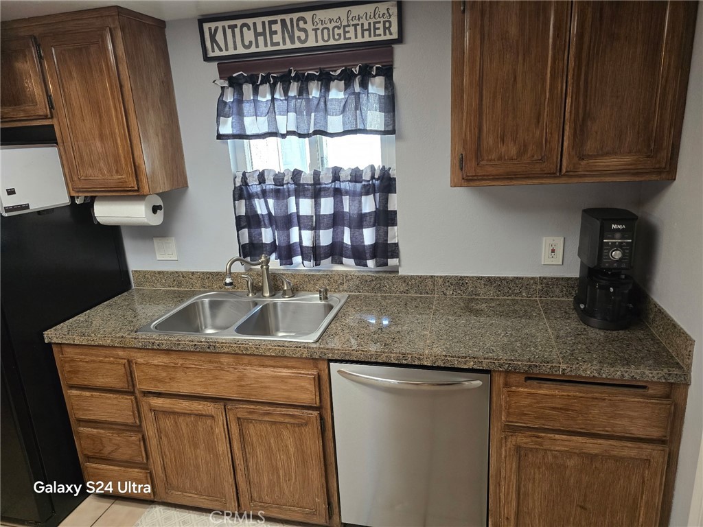 11504 Los Molinos Way Riverside, CA 92505 - Photo 10 of 40 a kitchen with granite countertop a sink a stove and cabinets