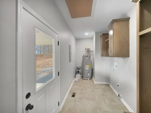 a hallway with furniture and natural light