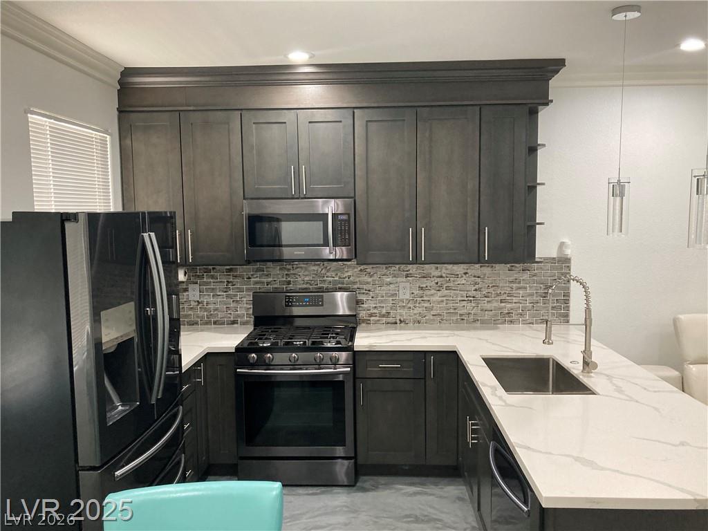 9050 West Warm Springs Road, Unit 1027 Las Vegas, NV 89148 - Photo 5 of 44 A well-appointed culinary space featuring dark cabinetry and light countertops for a sophisticated aesthetic.