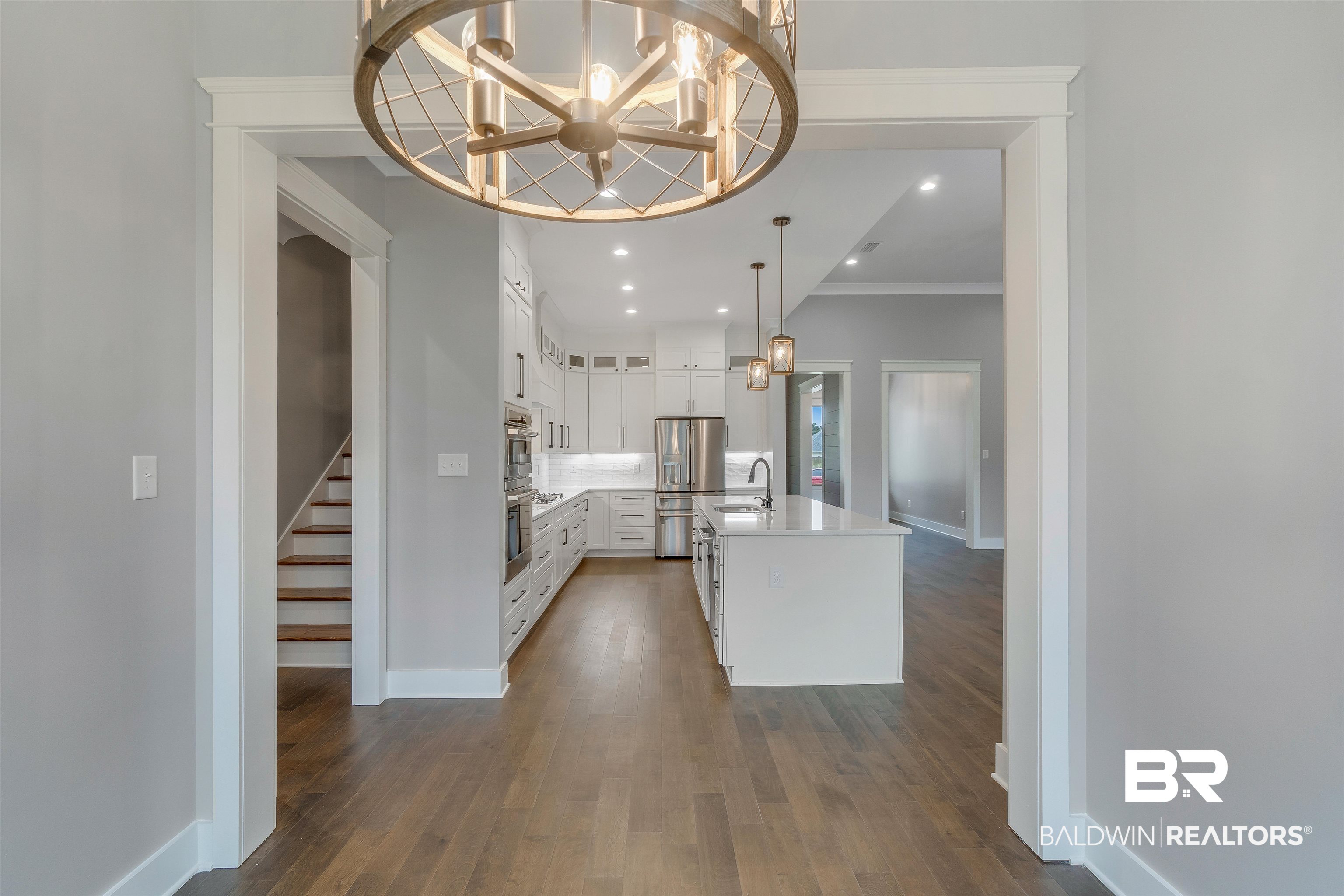 10985 Atrium Avenue Fairhope, AL 36532 - Photo 4 of 58 Kitchen featuring a chandelier, an island with sink, dark wood finished floors, pendant lighting, and recessed lighting